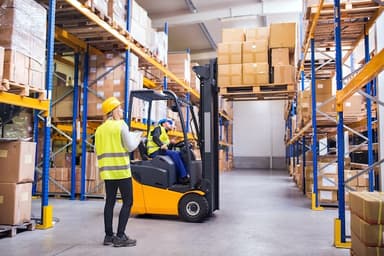 Warehouse team working alongside a forklift